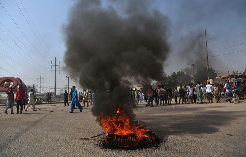 Supporters of a Pakistani religious group burn tires while block a main road during a protest after a court decision, in Karachi, Pakistan, Wednesday, Oct. 31, 2018. Pakistan's top court has acquitted a Christian woman who has been on death row since 2010