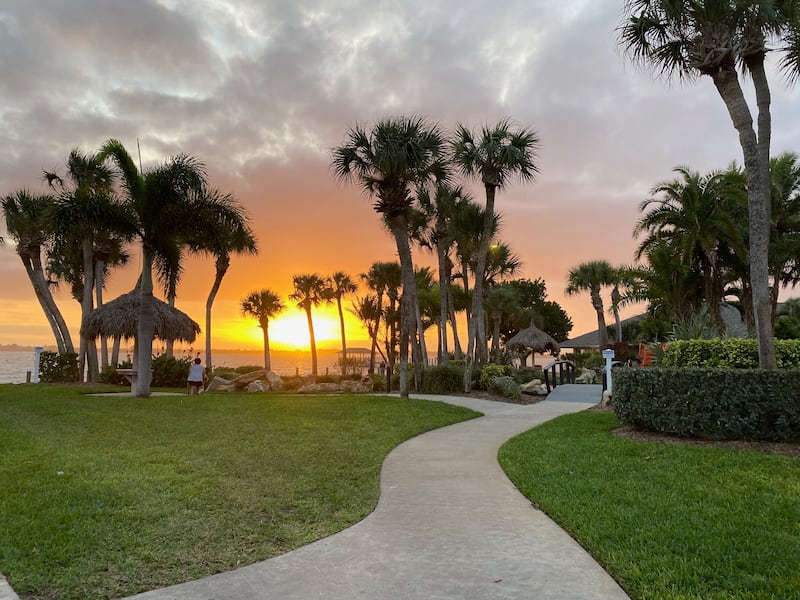 The sun sets over the Indian River at the Outdoor Resorts of Melbourne Beach Condo Association in Florida.