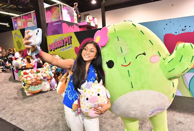 Creator Rushelyn Mauricio poses with Squishmallows mascot Maritza at VidCon with a SquishPit experience on June 22, 2023 in Anaheim, Calif.