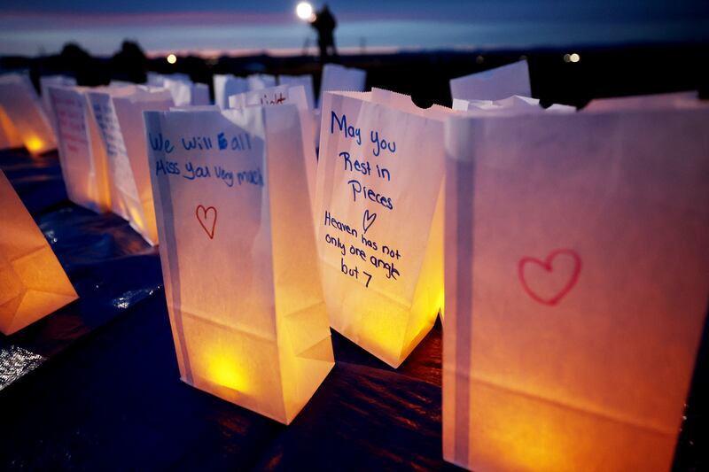 Messages are written on paper bags by residents of the town of Enoch, Iron County, in honor of Gail Earl and the Haight family.