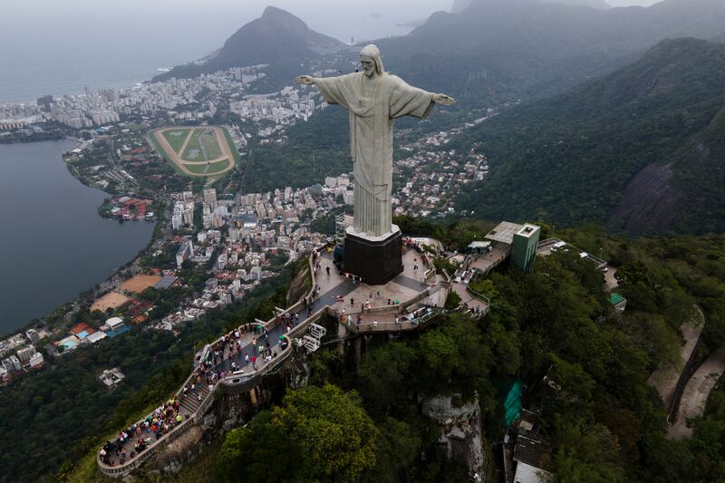 In this aerial image taken with a drone, the Christ the Redeemer statue stands above Rio de Janeiro, Brazil, Friday, Oct. 8, 2021. Rio Mayor Eduardo Paes confirmed that the statue will have a projection to honor Taylor Swift.