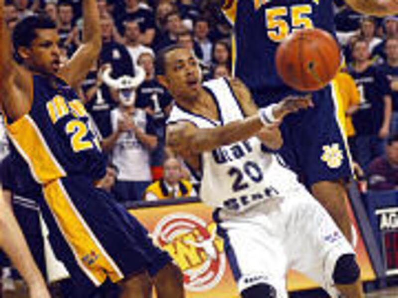 Utah State's Matt Brown passes ball while bracketed by UC Irvine's Mike Efevberha, left, Adam Parada.