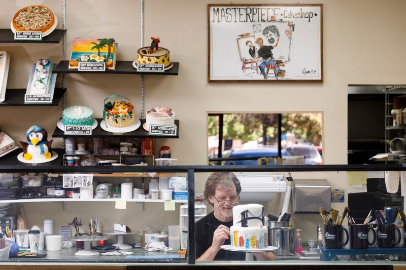 FILE - Jack Phillips, owner of Masterpiece Cakeshop in Lakewood, CO decorates a cake for a client on Sept. 21, 2017.