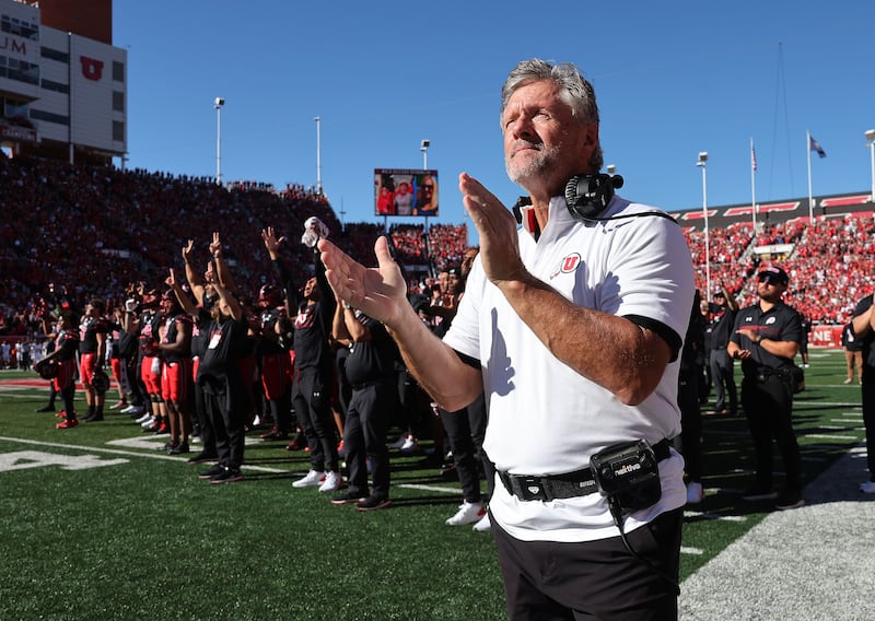 Utah Utes head coach Kyle Whittingham watches a video to honor Aaron Lowe and Ty Jordan