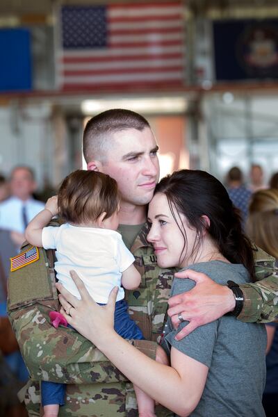 Alex Taylor of the Utah National Guard hugs his wife, Samantha Taylor, and daughter, 6-month-old Lydia Taylor, before being deployed to the Middle East at the Roland R. Wright Air National Guard Base in Salt Lake City on Monday, June 4, 2018.