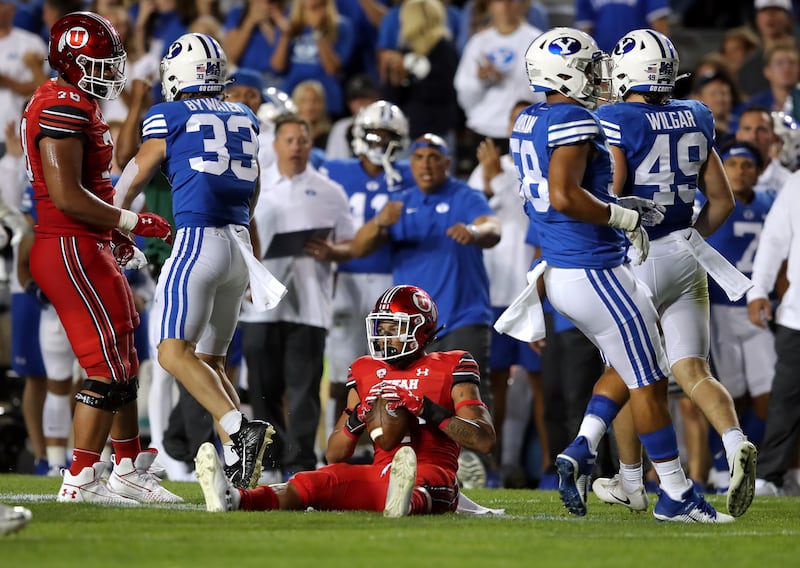 Utah running back Micah Bernard sits up after being tackled during game against BYU at LaVell Edwards Stadium in Provo, Utah.