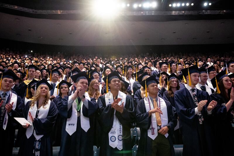 Brigham Young University students stand during the university’s commencement at the Marriott Center in Provo on April 27, 2023.