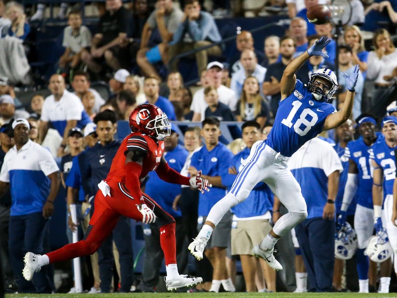 BYU receiver Gunner Romney (18) catches a pass from quarterback Zach Wilson while defended by Utah defensive back Jaylon Johnson.