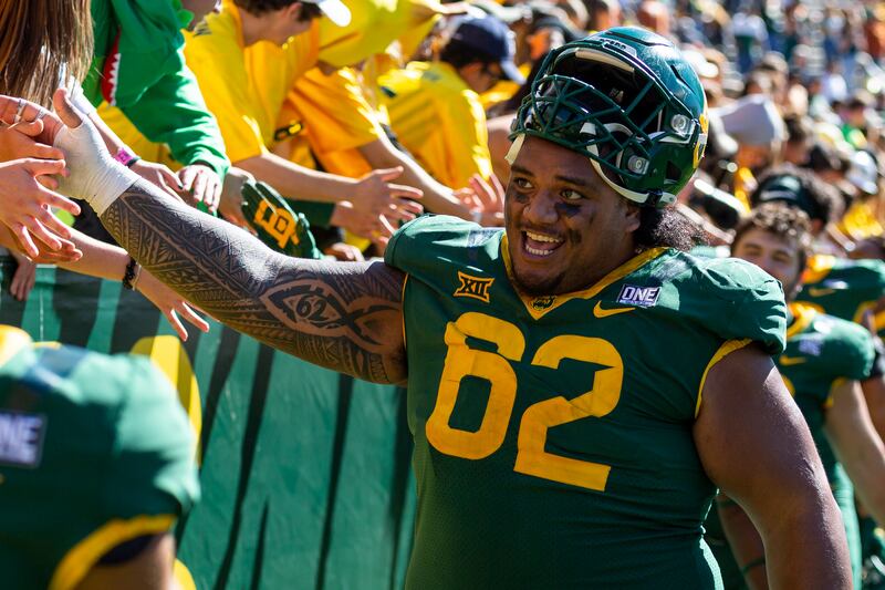 Baylor Bears defensive tackle Siaki Ika (62) celebrates with fans after an NCAA college football game against Texas, Saturday, Oct. 30, 2021, in Waco, Texas. Baylor won 31-24.