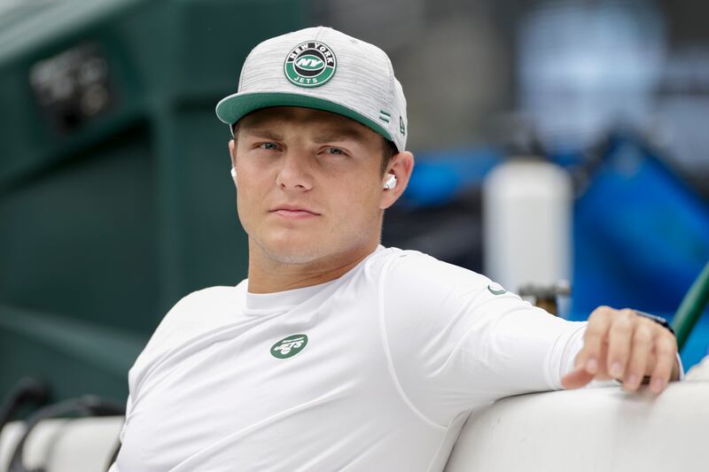 New York Jets quarterback Zach Wilson sits on the bench during practice before a preseason NFL football game against the New York Giants, Sunday, Aug. 28, 2022, in East Rutherford, N.J.