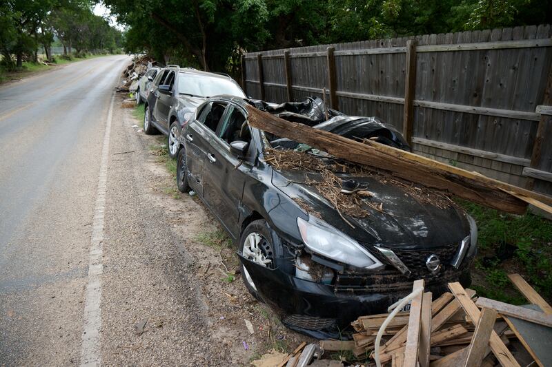 Damaged vehicles line a road near the Guadalupe River in Hunt, Texas, on July 26, 2025, after severe flooding claimed more than 135 lives and damaged homes and property in central Texas on July 4, 2025.