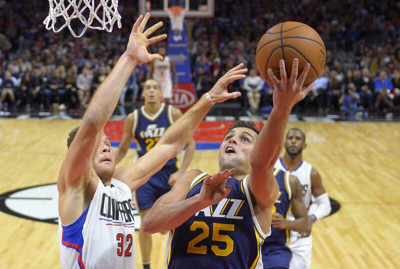 Utah Jazz guard Raul Neto, right, of Brazil, shoots as Los Angeles Clippers forward Blake Griffin defends during the second half of an NBA basketball game Wednesday, Nov. 25, 2015, in Los Angeles. The Jazz won 102-91. (AP Photo/Mark J. Terrill)