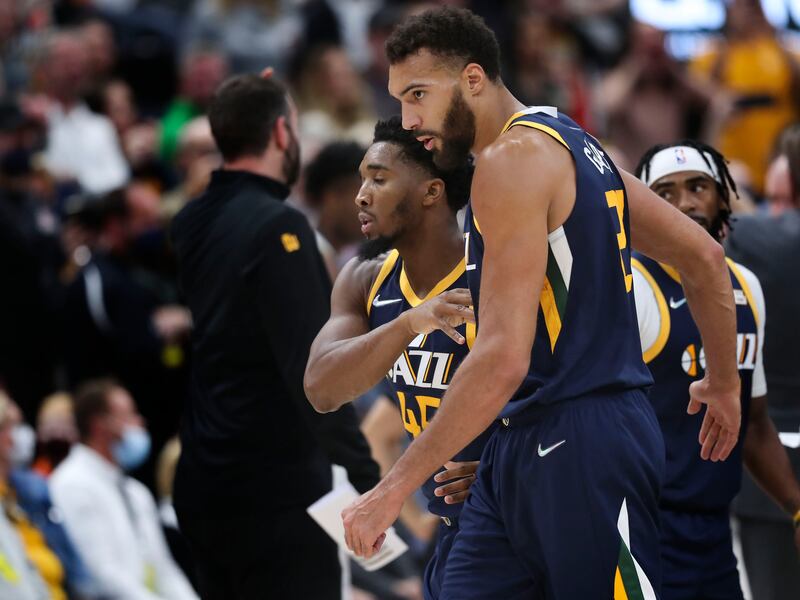 Utah Jazz guard Donovan Mitchell and Utah Jazz center Rudy Gobert walk off the court.