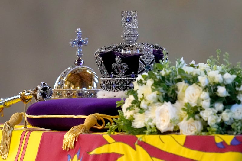 The coffin of Queen Elizabeth II, draped in the Royal Standard with the Imperial State Crown and the Sovereign’s orb and sceptre, lying in state on the catafalque as members of the public file past in Westminster Hall, at the Palace of Westminster, in London, Friday, Sept. 16, 2022, ahead of her funeral on Monday.