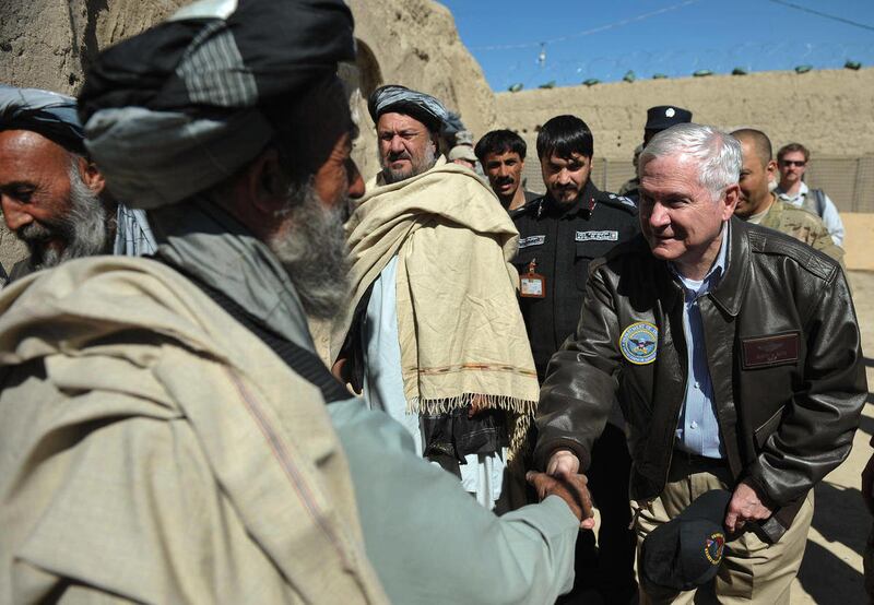 US Defense Secretary Robert Gates, right, greets village elders before meeting with the village council during a visit to Combat Outpost Kowall, Afghanistan, Tuesday March 8, 2011, west of the city of Kandahar, in southern Afghanistan. US Defense Secreta