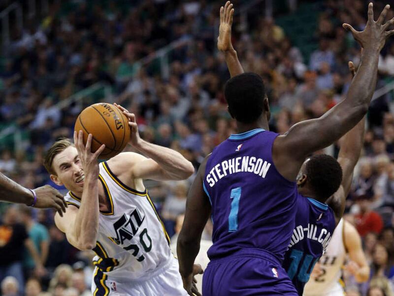 Gordon Hayward (20) of the Utah Jazz drives to the basket with Lance Stephenson (1) and Michael Kidd-Gilchrist (14) of the Charlotte Hornets defending during NBA basketball in Salt Lake City, Monday, March 16, 2015.