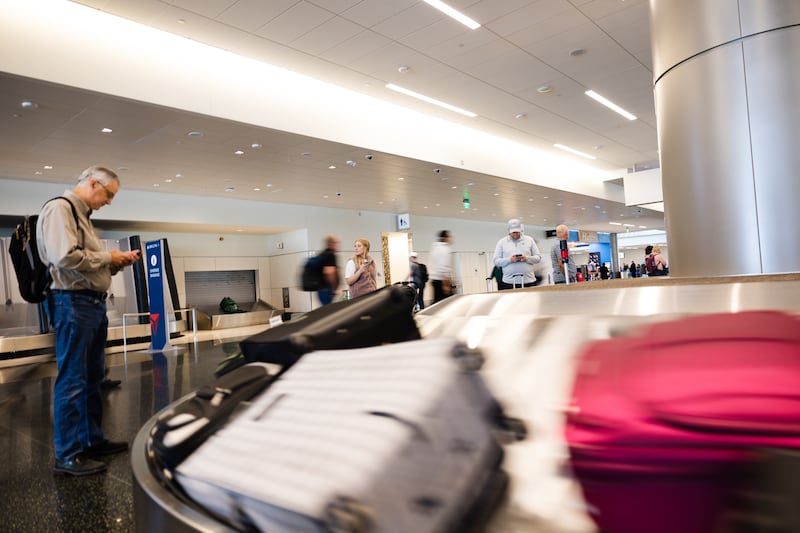 Travelers wait to pick up their luggage at the Salt Lake City International Airport in Salt Lake City on Friday, May 19, 2023.