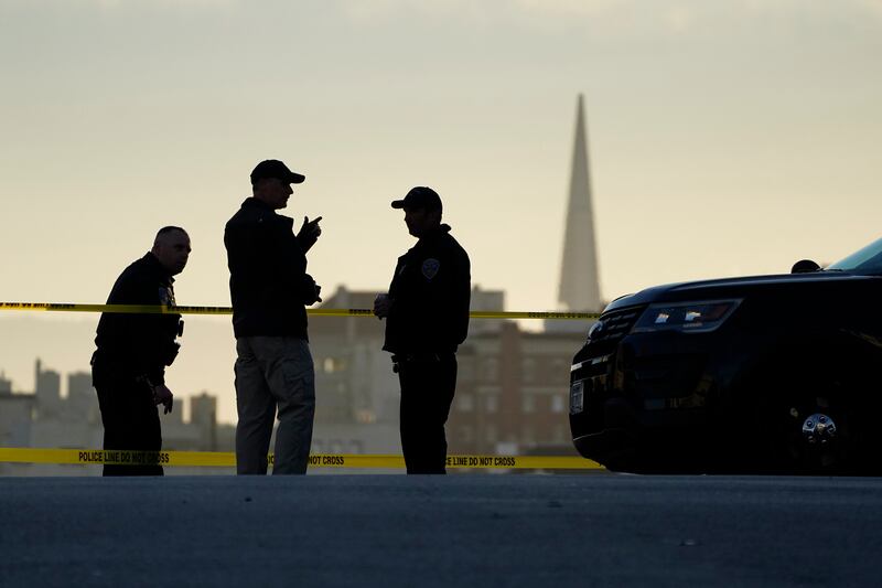 Police stand at the top of the closed street outside the home of House Speaker Nancy Pelosi and her husband Paul Pelosi.