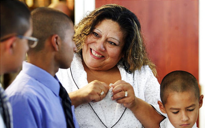 Ruth Gonzalez smiles with her foster children after a West Jordan City Hall ceremony honoring her and her husband.