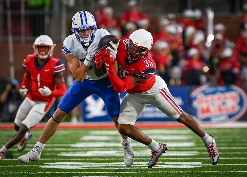 Liberty’s Tyren Dupree, right, battles against BYU’s Ethan Erickson during an NCAA college football game in Lynchburg, Va., Saturday, Oct. 22, 2022.