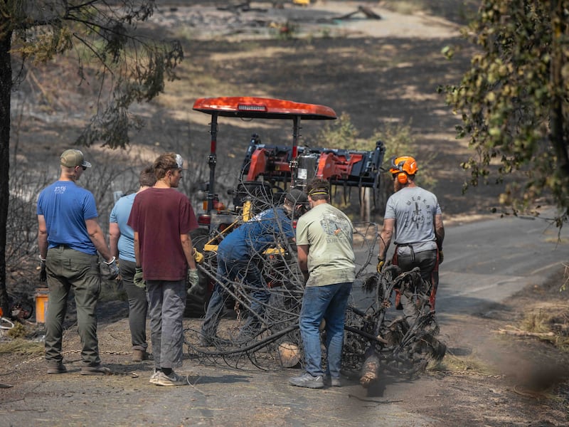 Young men and leaders from the Spokane Washington Mount Spokane Stake help clear debris from a neighborhood damaged by wildfires in Spokane, Washington, on Monday, Aug. 3, 2026.