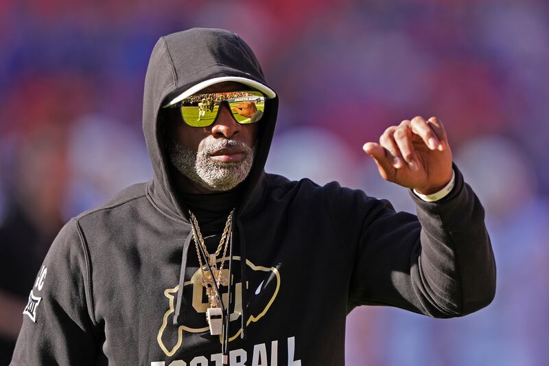 Colorado head coach Deion Sanders watches warmups before an NCAA college football game against Kansas Saturday, Nov. 23, 2024, in Kansas City, Mo. (AP Photo/Charlie Riedel)