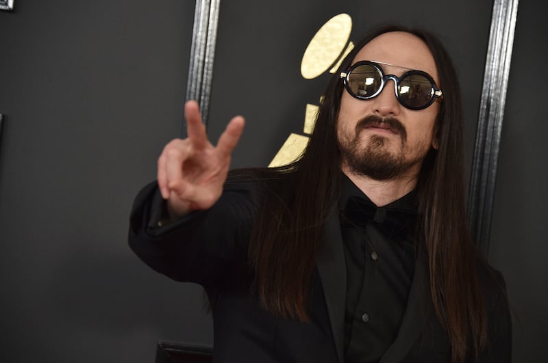 Steve Aoki threw out the first pitch at the Red Sox-Astros game Monday, overthrowing the pitch into the netting above the seats behind home plate.