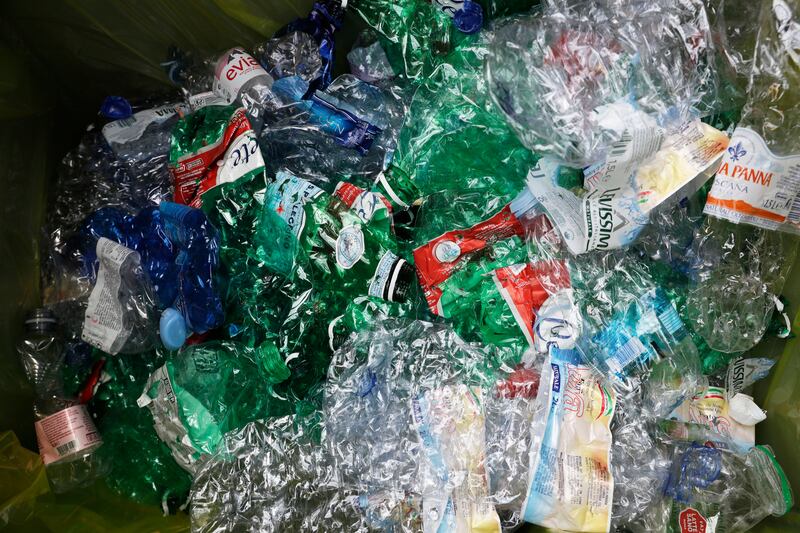 Plastic bottles are seen inside an automatic recycling bin outside a subway station in Rome.