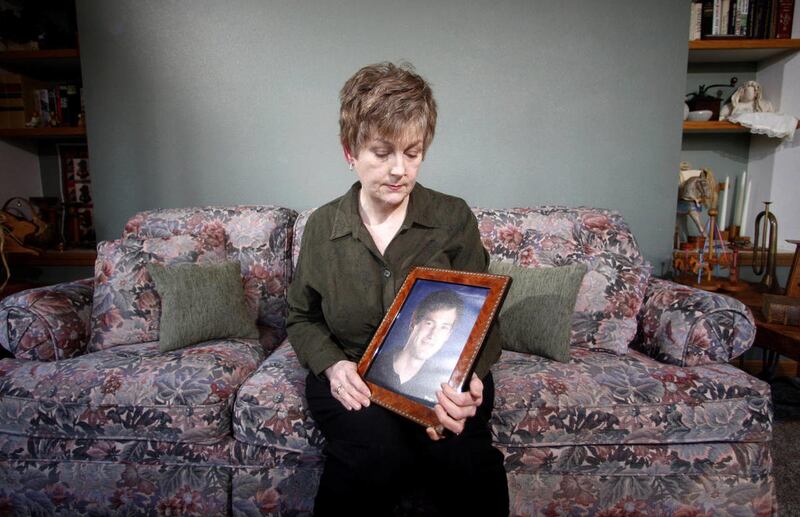 FILE – In this Monday, Feb. 27, 2012 file photo, Karen Williams, who sued Facebook for access to her 22-year-old son Loren’s account after he died in a 2005 motorcycle accident, looks at a portrait of her son at her home in Beaverton, Ore. The Uniform Law