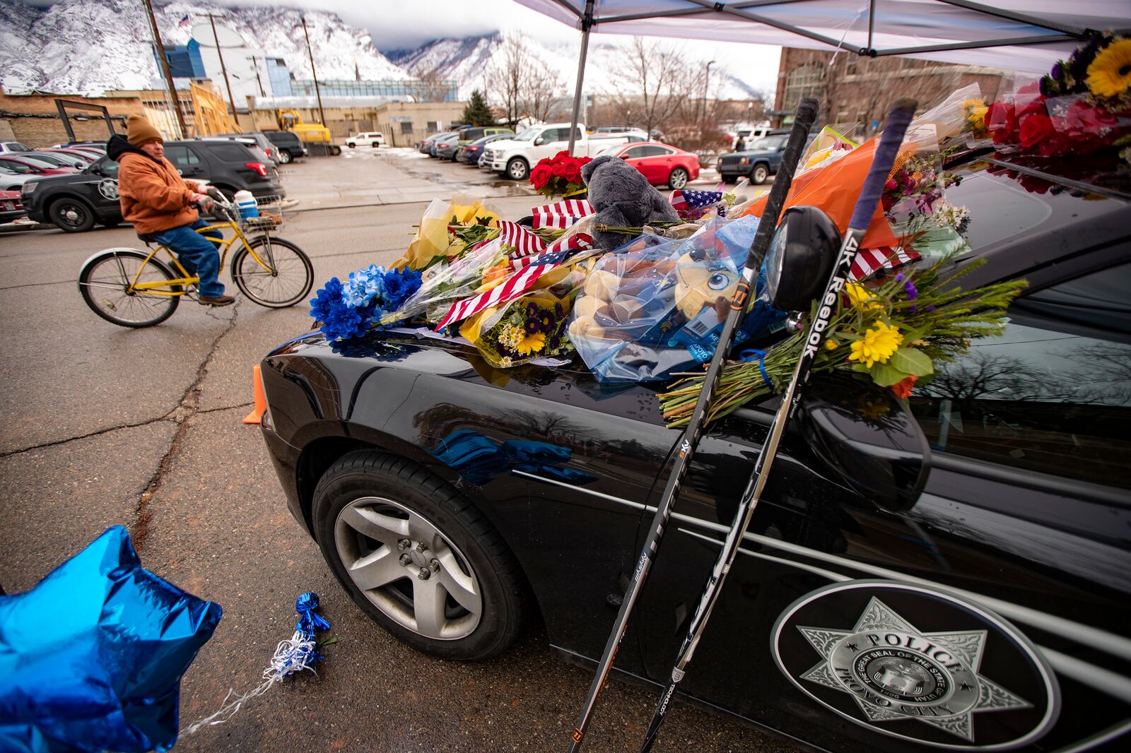 Flowers and other items cover slain Provo police officer Joseph Shinners’ patrol car at Provo Police Department headquarters.