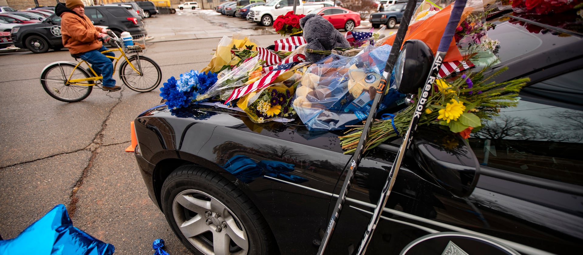 Flowers and other items cover slain Provo police officer Joseph Shinners’ patrol car at Provo Police Department headquarters.