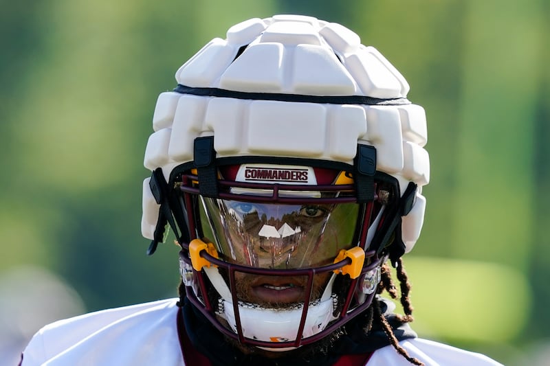 Washington Commanders running back Jonathan Williams wears a Guardian cap football helmet during practice at the team’s NFL football training facility in Ashburn, Va.