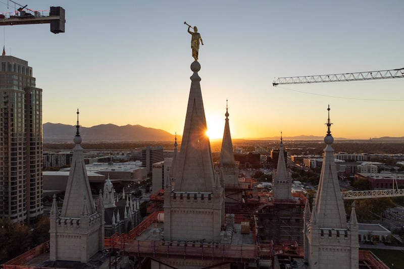 The sun sets behind the Salt Lake Temple on Saturday, Oct. 5, 2024.
