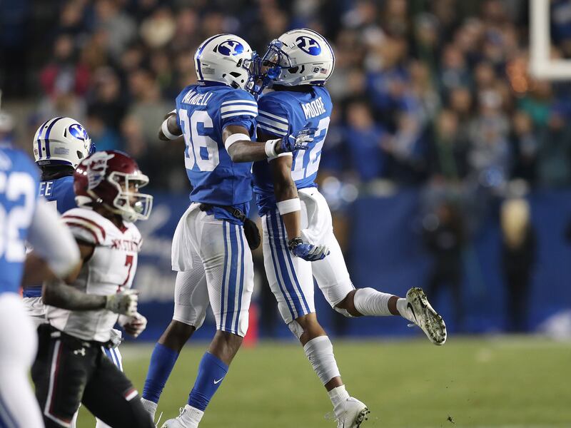 BYU defensive back defensive back D’Angelo Mandell, left, celebrates Malik Moore’s interception.