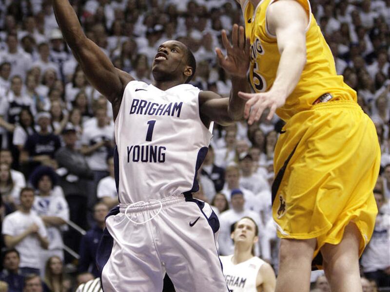Brigham Young Cougars guard/forward Charles Abouo (1) shoots by Wyoming Cowboys center Adam Waddell (15)  in Provo, Utah, Saturday, March 5, 2011.