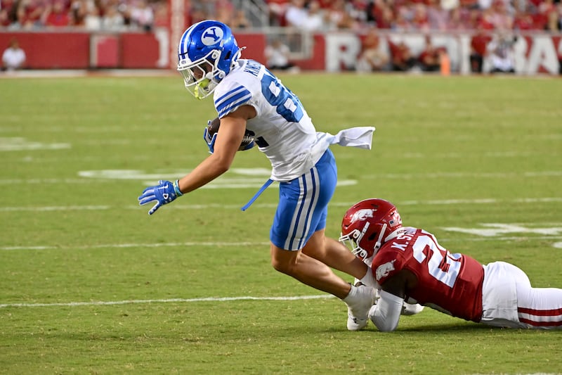 BYU wide receiver Parker Kingston is tackled by Arkansas' Kee'yon Stewart during a game Saturday, Sept. 16, 2023, in Fayetteville, Ark.