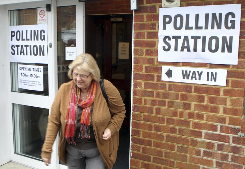 A resident leaves the polling station after casting her vote in the Eastleigh by-election in West End, Hampshire, southern England Thursday Feb. 28, 2013. Britain's political parties are contesting a special election after a campaign overshadowed by scan