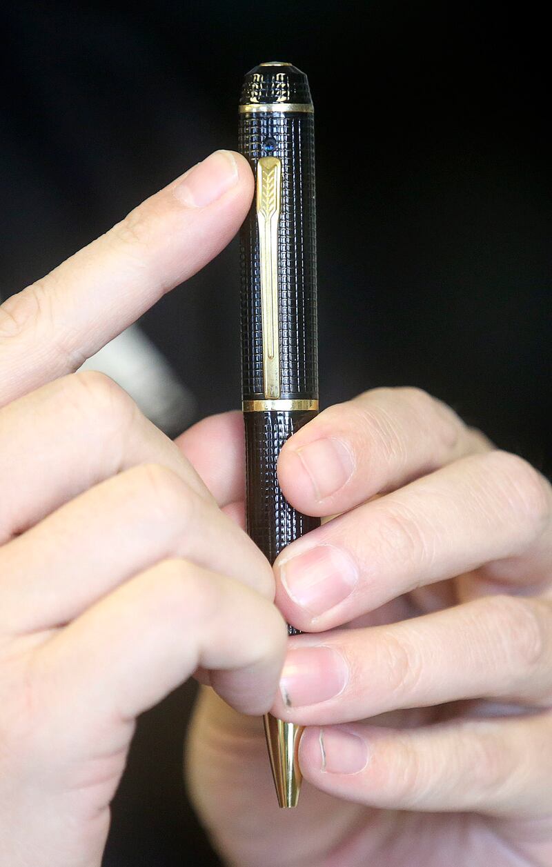 Thal Dixon points out a hidden camera on a pen at Dixon Security Cameras in South Salt Lake on Tuesday, March 12, 2019.