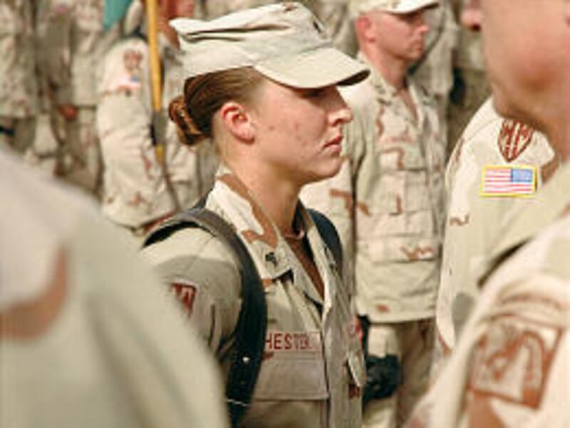 Sgt. Leigh Ann Hester stands at attention before receiving Silver Star in Iraq.