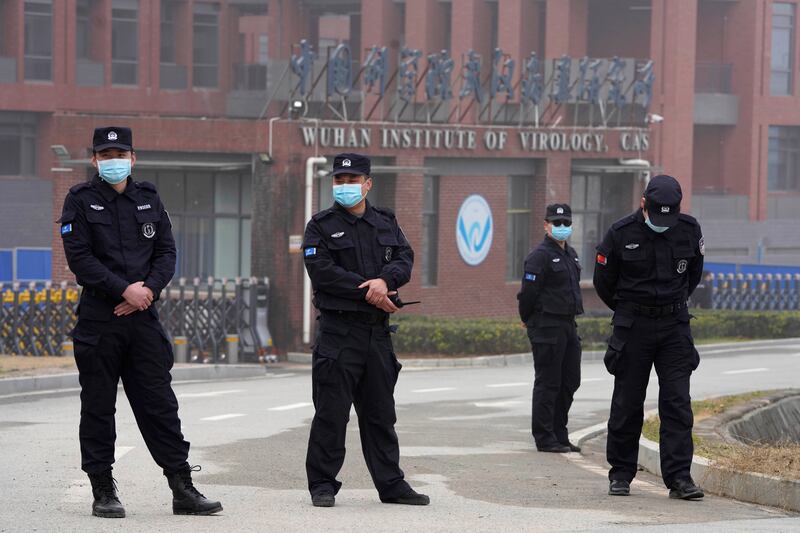 Security personnel gather near the entrance of the Wuhan Institute of Virology in Wuhan in China’s Hubei province.
