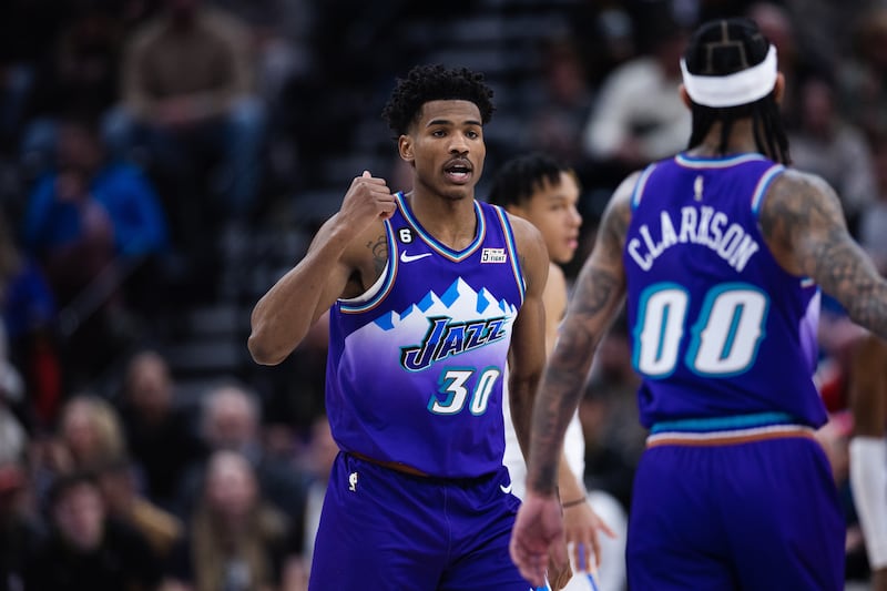 Utah Jazz guard Ochai Agbaji (30) signals to teammate Jordan Clarkson (00) during an NBA game at Vivint Arena.