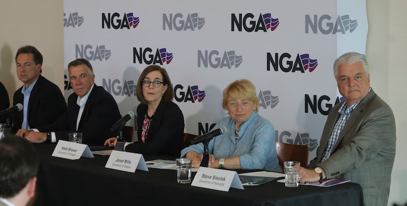 FILE - From left to right, Montana Gov. Steve Bullock, Vermont Gov. Phil Scott, Oregon Gov. Kate Brown, Maine Gov. Janet Mills and Nevada Gov. Steve Sisolak look on during a news conference launching an Outdoors Recreation Initiative Wednesday, July 24, 2