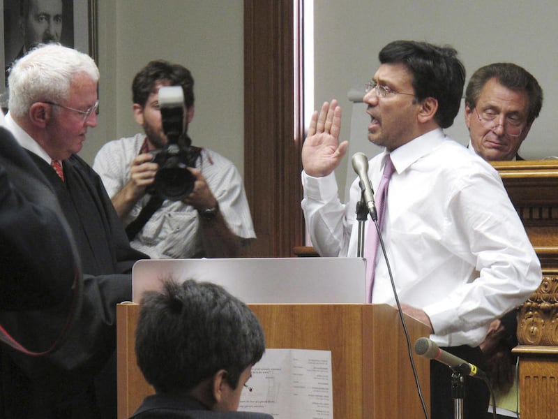 In this photo of July 26, 2011, New Jersey Superior Court Judge Sohail Mohammed raises his right hand as he is administered the oath of office by his mentor, retired Passaic County Assignment Judge Robert J. Passero, left, at Mohammed's ceremonial swearin