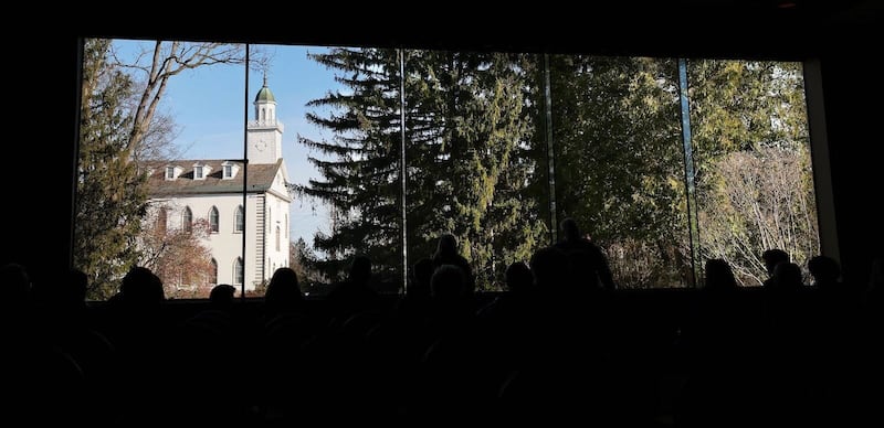 The Kirtland Temple shines brightly in the large picture window at the Kirtland Temple Visitors' Center on Monday, March 25, 2024, in Kirtland, Ohio.