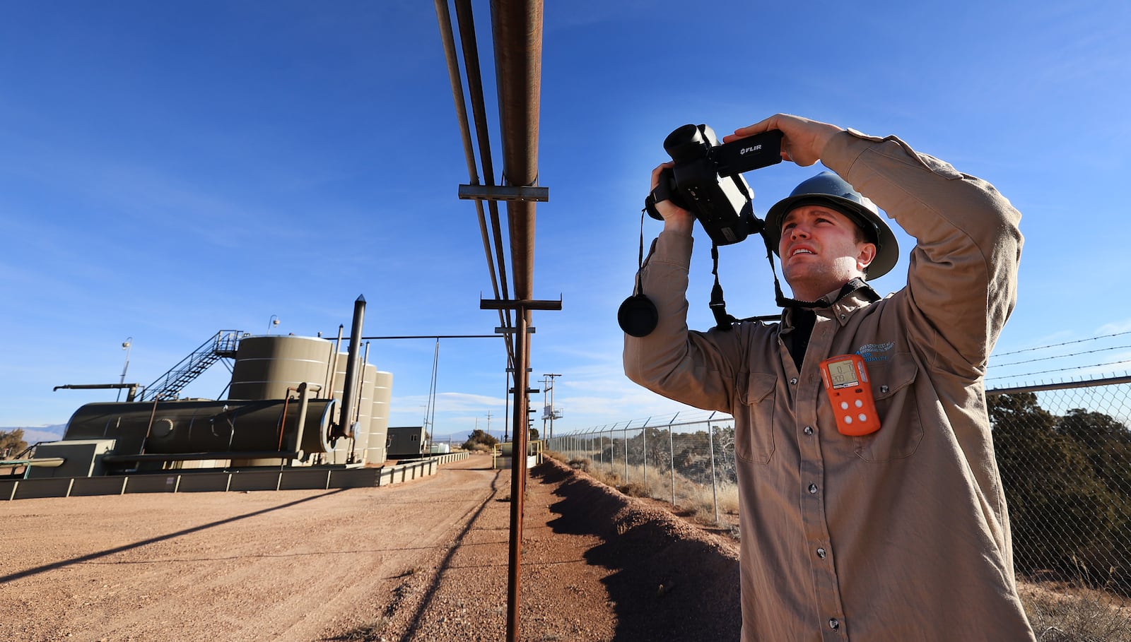 Stephen Foulger, with the Utah Department of Environmental Quality, inspects an oil pump site near Roosevelt.