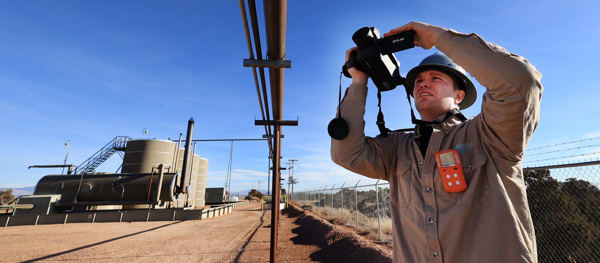 Stephen Foulger, with the Utah Department of Environmental Quality, inspects an oil pump site near Roosevelt.