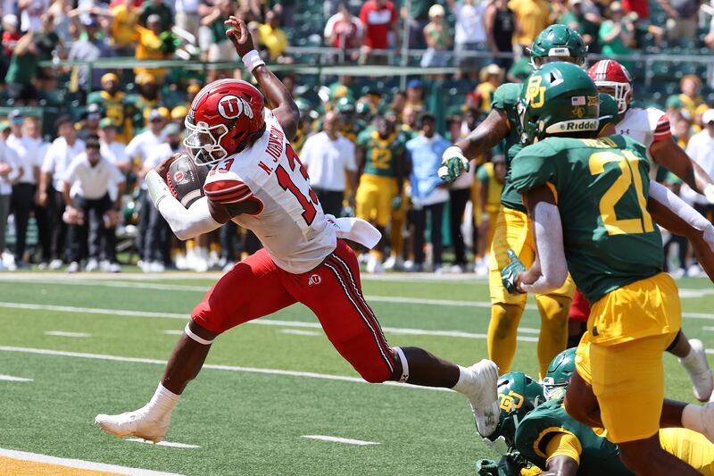 Utah quarterback Nate Johnson (13) scores a touchdown against Baylor