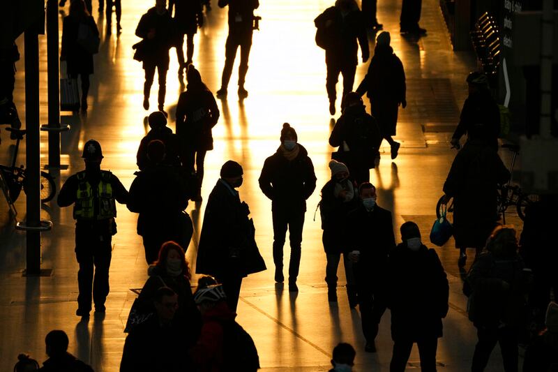 People pass through Waterloo train station.
