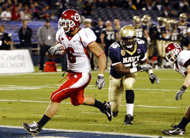 Utah's Darrell Mack outruns Navy's Irv Spencer into the endzone on a five yard touchdown run in the second quarter during the Poinsettia Bowl football game on Thursday, Dec. 20, 2007 in San Diego. (AP Photo/Chris Park)