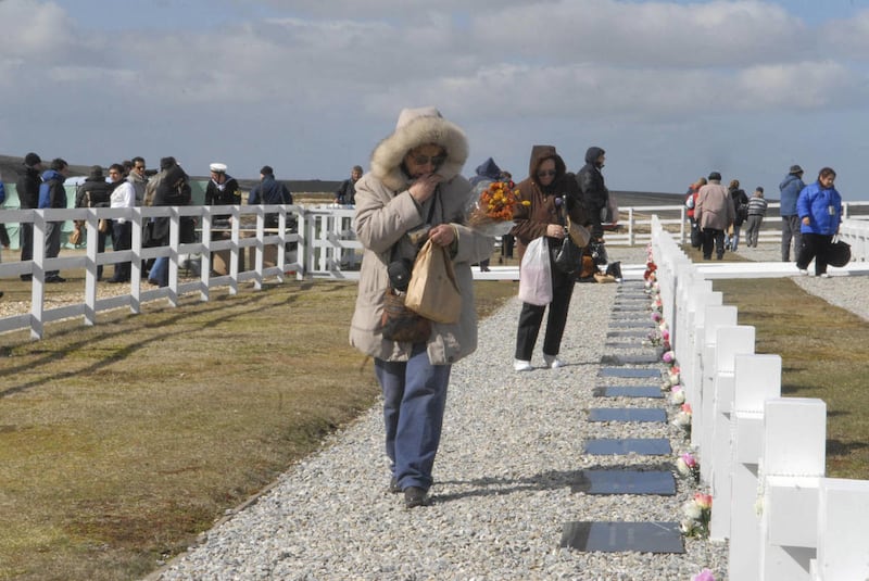 In this Oct. 3, 2009 file picture, released by Argentina's Foreign Ministry, relatives of Argentine soldiers who died in the 1982 Falklands war between Argentina and Great Britain search for their tombstones in a cemetery in Darwin, East Falkland Island.